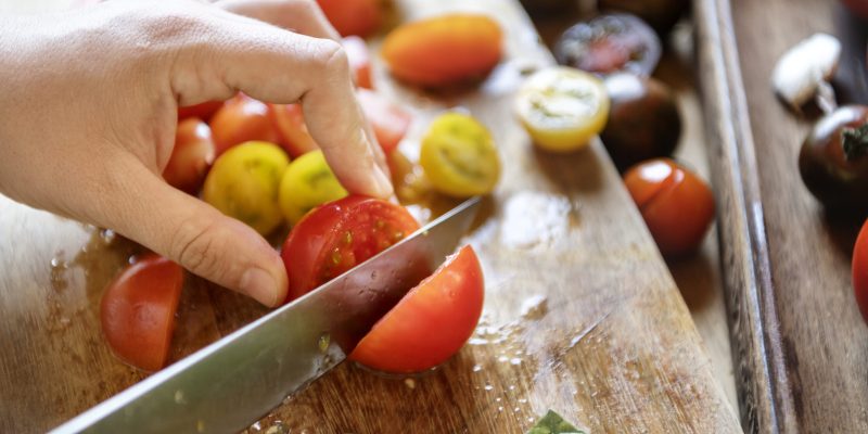 Chopping tomatoes on a cutting board